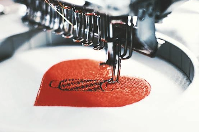 Embroidery Machine Stitching Red Heart Design on Fabric
