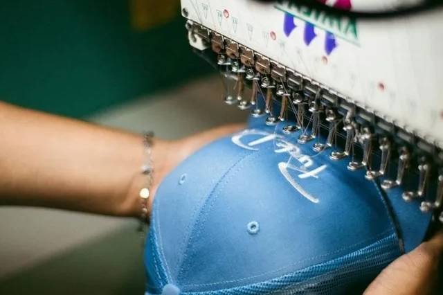 Machine Stitching Embroidery on Blue Cap in Embroidery Shops